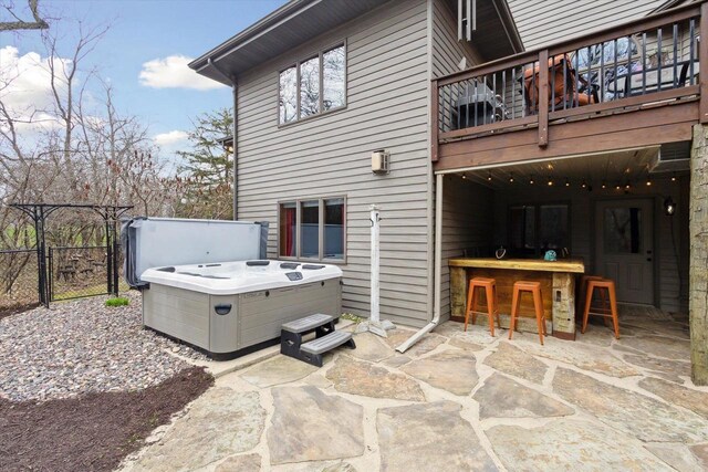 2555 W Deer Path Trl, Janesville, WI 53545 - rear view of house featuring outdoor dry bar, a balcony, a hot tub, and a patio