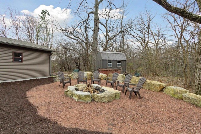 2555 W Deer Path Trl, Janesville, WI 53545 - view of yard with an outdoor structure and an outdoor fire pit
