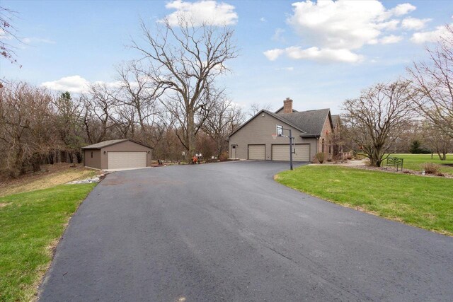 2555 W Deer Path Trl, Janesville, WI 53545 - exterior space with a chimney, a front lawn, and an outdoor structure