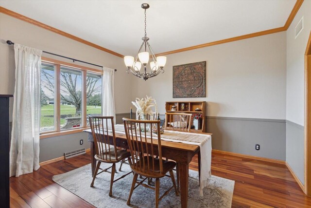 2555 W Deer Path Trl, Janesville, WI 53545 - dining space with wood finished floors, visible vents, crown molding, baseboards, and a chandelier