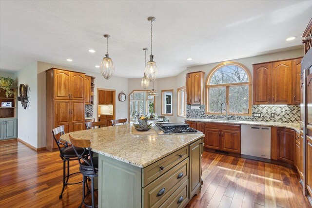 2555 W Deer Path Trl, Janesville, WI 53545 - kitchen with a sink, light stone counters, a breakfast bar, a kitchen island, and appliances with stainless steel finishes