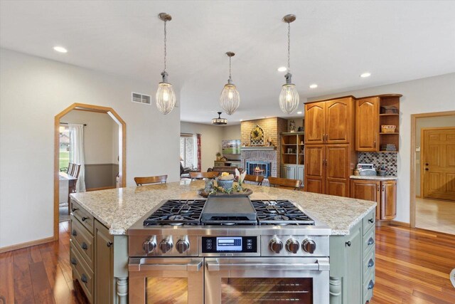 2555 W Deer Path Trl, Janesville, WI 53545 - kitchen with a healthy amount of sunlight, light wood-type flooring, double oven range, visible vents, and open shelves