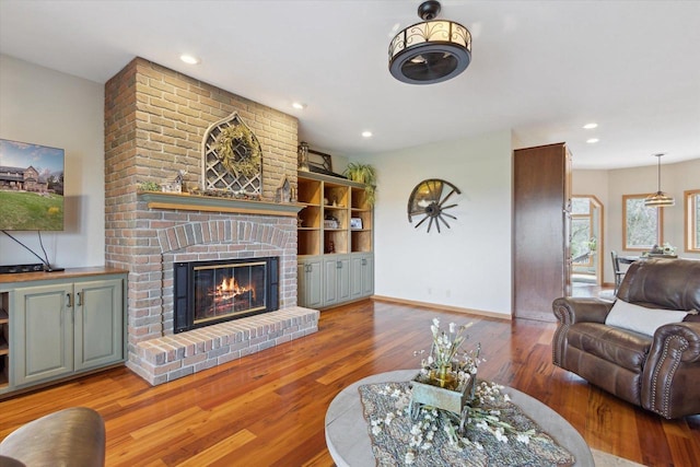 2555 W Deer Path Trl, Janesville, WI 53545 - living area featuring hardwood / wood-style floors, baseboards, a brick fireplace, and recessed lighting