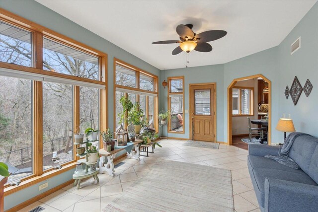 2555 W Deer Path Trl, Janesville, WI 53545 - tiled living room featuring baseboards, a ceiling fan, visible vents, and arched walkways