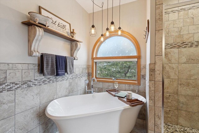 2555 W Deer Path Trl, Janesville, WI 53545 - bathroom with tile walls, wainscoting, and a freestanding bath