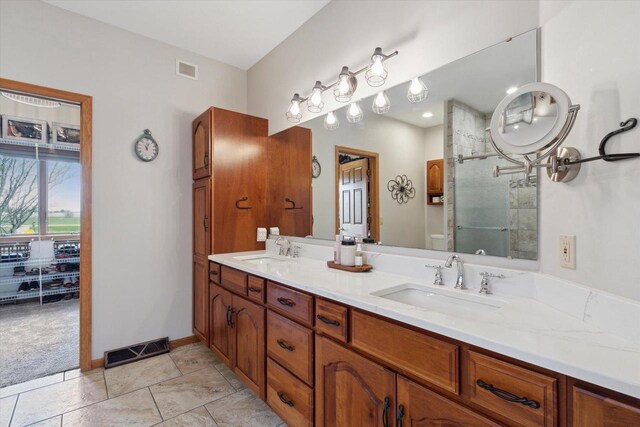 2555 W Deer Path Trl, Janesville, WI 53545 - bathroom with visible vents, tiled shower, and a sink
