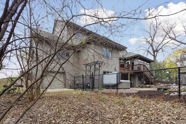 2555 W Deer Path Trl, Janesville, WI 53545 - view of property exterior with a gate, a wooden deck, and fence