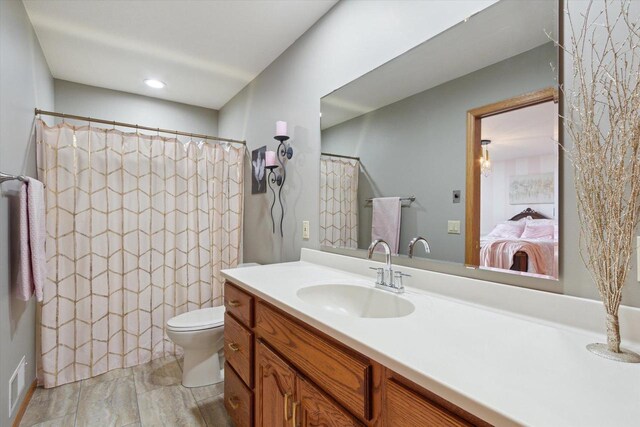 2555 W Deer Path Trl, Janesville, WI 53545 - bathroom with ensuite bathroom, vanity, curtained shower, and toilet