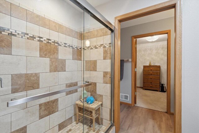 2555 W Deer Path Trl, Janesville, WI 53545 - full bath with a shower stall, wood finished floors, and visible vents