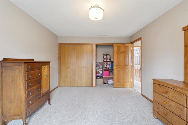 2555 W Deer Path Trl, Janesville, WI 53545 - bedroom with baseboards, a closet, and light colored carpet