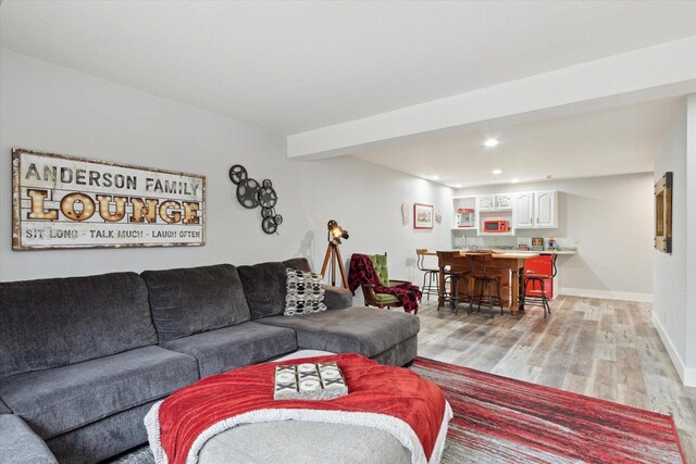 2555 W Deer Path Trl, Janesville, WI 53545 - living room featuring recessed lighting, light wood-type flooring, baseboards, and indoor wet bar