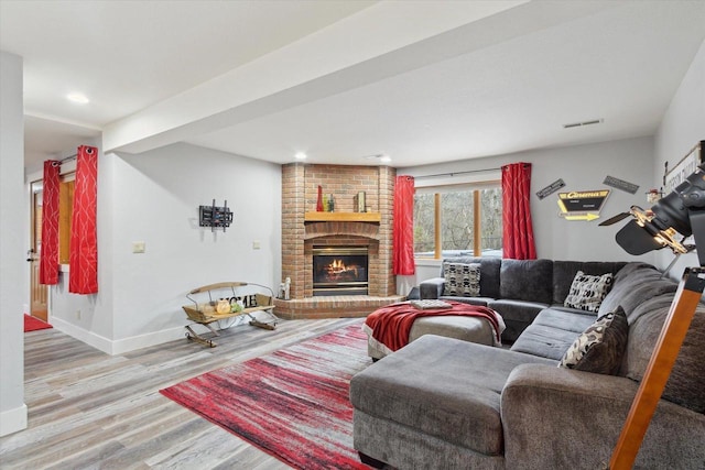 2555 W Deer Path Trl, Janesville, WI 53545 - living area with wood finished floors, a fireplace, baseboards, visible vents, and recessed lighting