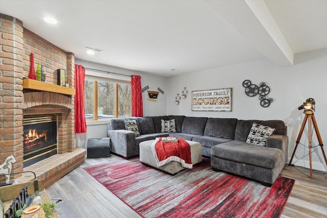 2555 W Deer Path Trl, Janesville, WI 53545 - living area with visible vents, wood finished floors, and a fireplace