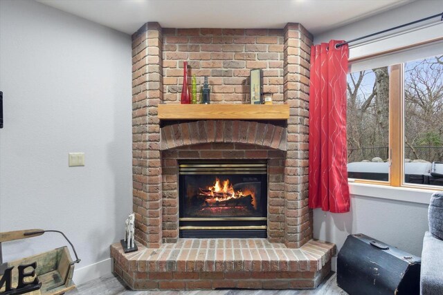 2555 W Deer Path Trl, Janesville, WI 53545 - interior details with baseboards, a brick fireplace, and wood finished floors