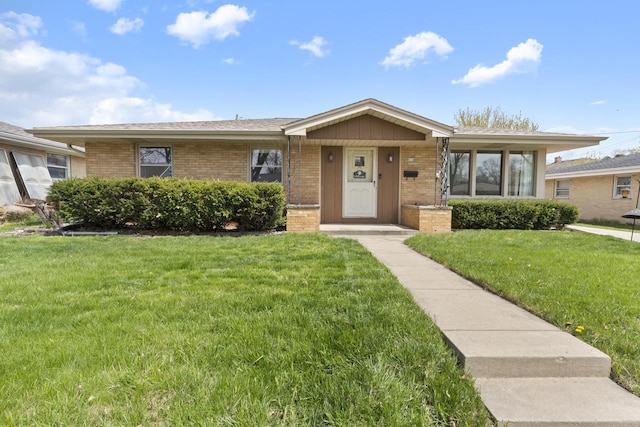 ranch-style home with brick siding and a front yard