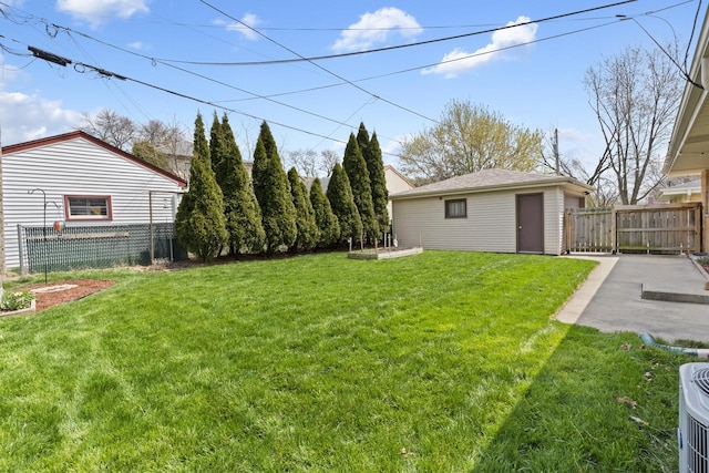 view of yard with fence, an outdoor structure, and cooling unit