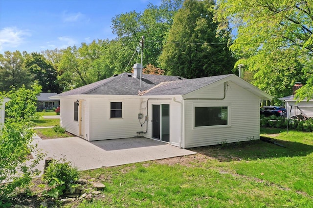 W160N9696 Colonial Dr, Germantown, WI 53022 - rear view of property with a patio area, a lawn, a shingled roof, and a chimney