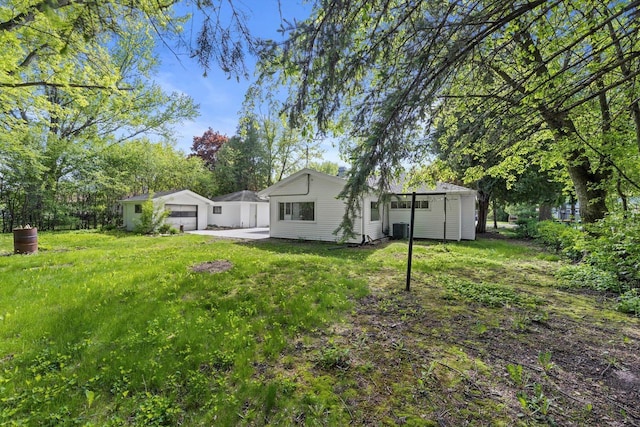 W160N9696 Colonial Dr, Germantown, WI 53022 - view of green lawn with an outbuilding, central AC, and a garage