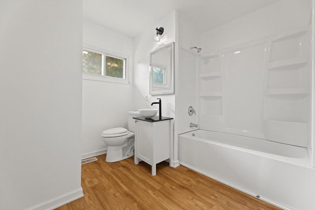 W160N9696 Colonial Dr, Germantown, WI 53022 - bathroom with vanity, wood finished floors, toilet, shower / bathtub combination, and baseboards