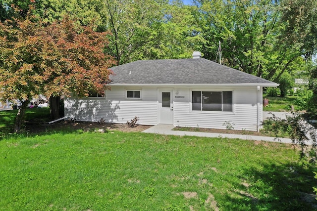 W160N9696 Colonial Dr, Germantown, WI 53022 - view of front of house featuring a front lawn, roof with shingles, and a chimney