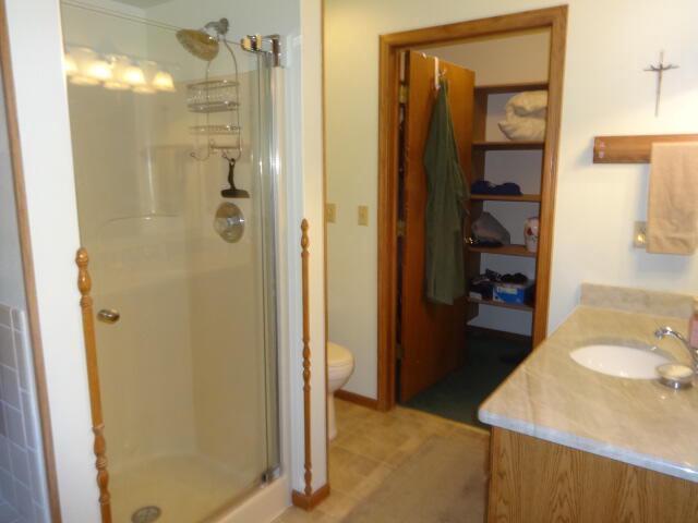 545 Skyhawk Ave, Campbellsport, WI 53010 - full bath with vanity, a stall shower, and toilet
