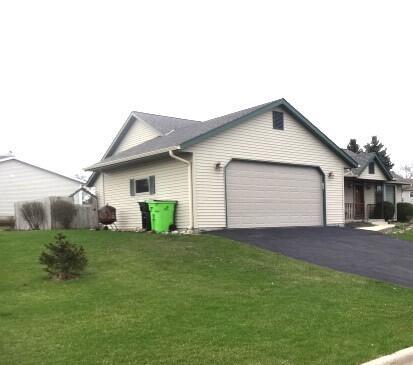 545 Skyhawk Ave, Campbellsport, WI 53010 - view of home's exterior featuring a garage, a lawn, and driveway