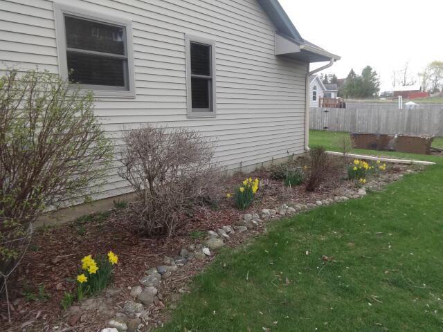 545 Skyhawk Ave, Campbellsport, WI 53010 - view of side of property featuring a lawn and fence