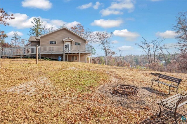 W7604 Sleepy Eye Rd, Minong, WI 54859 - exterior space with a fire pit and a deck