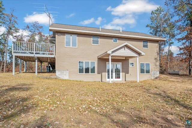 W7604 Sleepy Eye Rd, Minong, WI 54859 - rear view of house featuring a wooden deck and a yard