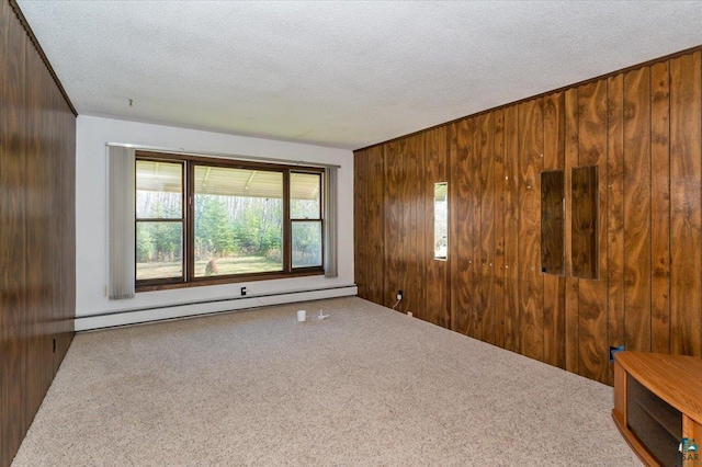 2608 Logan Ave, Superior, WI 54880 - carpeted empty room with wooden walls, a textured ceiling, and baseboard heating