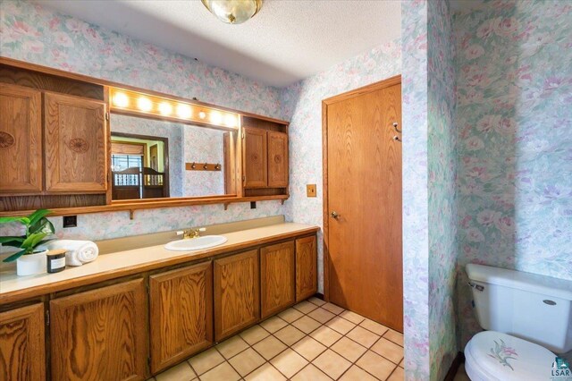 2608 Logan Ave, Superior, WI 54880 - bathroom with vanity, toilet, tile patterned flooring, and wallpapered walls