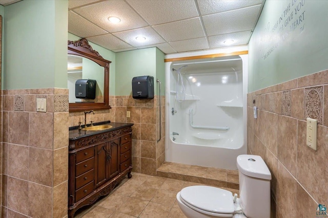 2608 Logan Ave, Superior, WI 54880 - full bath with tile walls, a wainscoted wall, a shower, toilet, and tile patterned flooring