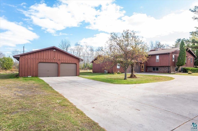 2608 Logan Ave, Superior, WI 54880 - ranch-style house with a front lawn, an outbuilding, a detached garage, and board and batten siding