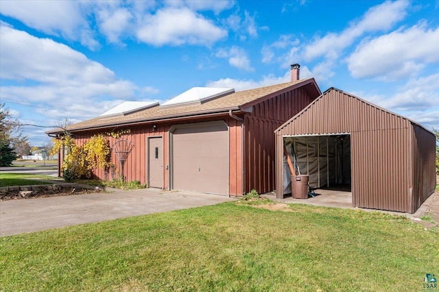 2608 Logan Ave, Superior, WI 54880 - exterior space with a garage, a lawn, board and batten siding, and a chimney