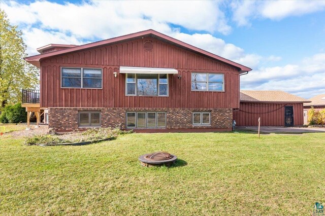 2608 Logan Ave, Superior, WI 54880 - view of property exterior featuring brick siding, a lawn, and a fire pit