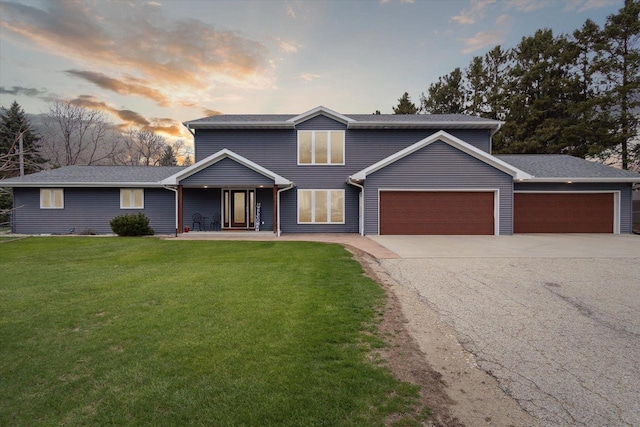 4441 N John Paul Rd, Milton, WI 53546 - traditional home with a front lawn, aphalt driveway, and an attached garage