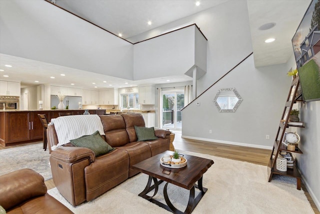 4441 N John Paul Rd, Milton, WI 53546 - living room featuring recessed lighting, light wood-style flooring, baseboards, and a high ceiling