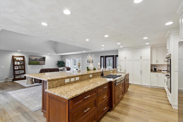4441 N John Paul Rd, Milton, WI 53546 - kitchen featuring a large island, stainless steel gas stovetop, light wood-type flooring, and recessed lighting