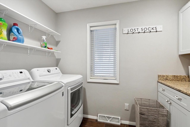 4441 N John Paul Rd, Milton, WI 53546 - clothes washing area with dark wood-style floors, cabinet space, separate washer and dryer, visible vents, and baseboards