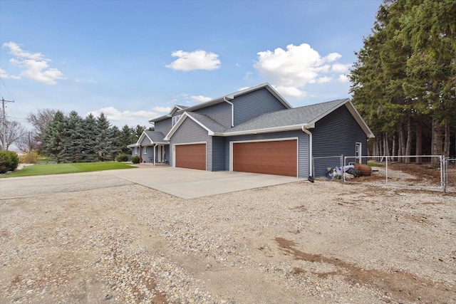 4441 N John Paul Rd, Milton, WI 53546 - view of home's exterior with a garage, fence, concrete driveway, and roof with shingles