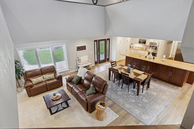 4441 N John Paul Rd, Milton, WI 53546 - living area featuring visible vents, light wood-type flooring, and high vaulted ceiling