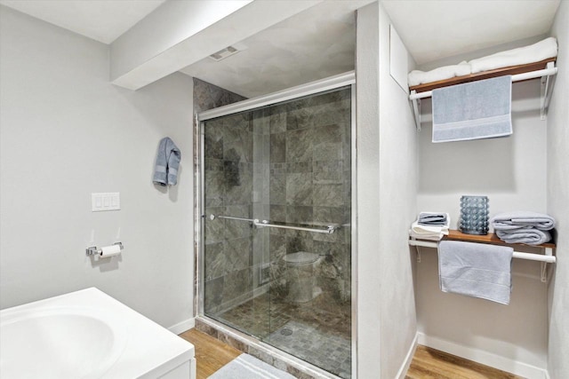 4441 N John Paul Rd, Milton, WI 53546 - full bathroom with baseboards, wood finished floors, a shower stall, and a sink