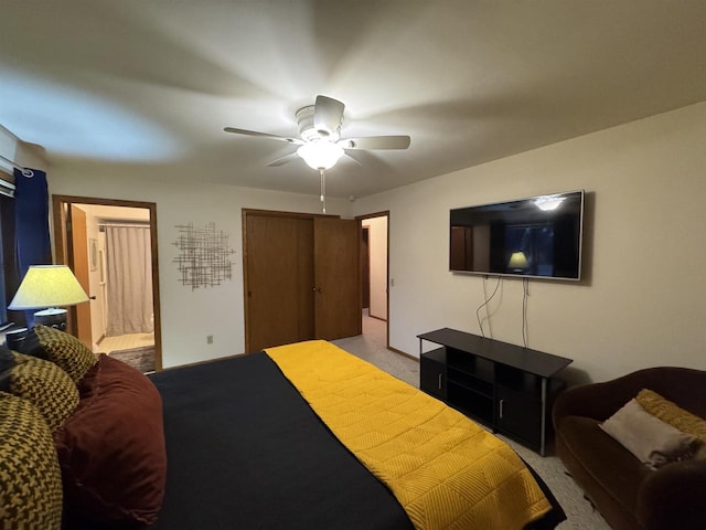 carpeted bedroom featuring connected bathroom and ceiling fan