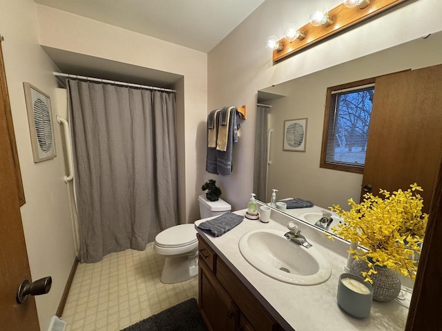 bathroom with toilet, vanity, and curtained shower