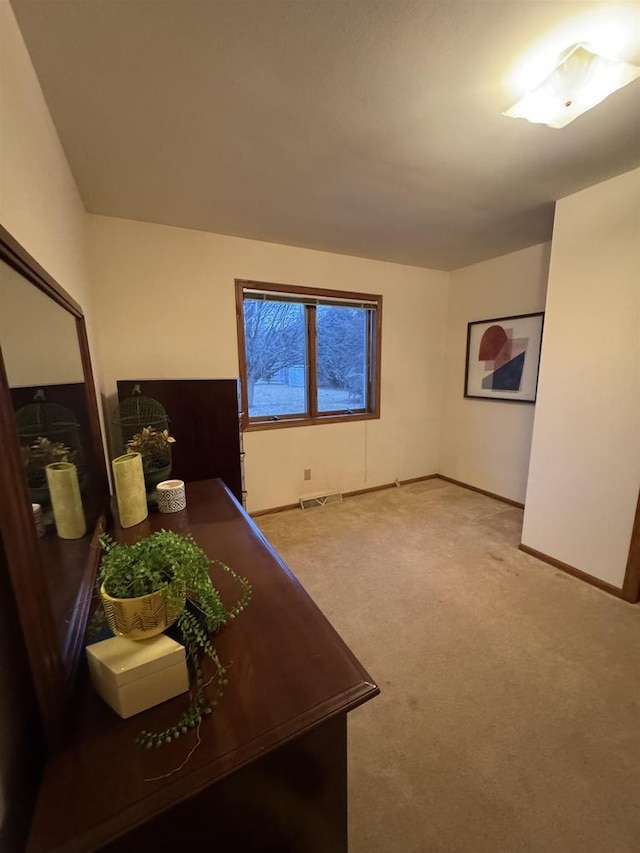interior space featuring carpet floors, visible vents, and baseboards