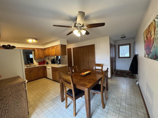 dining space featuring baseboards and ceiling fan