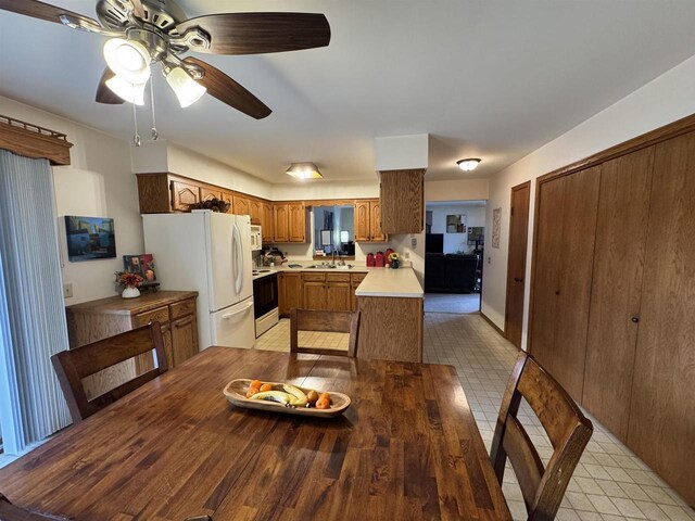 dining area with ceiling fan and light tile patterned floors