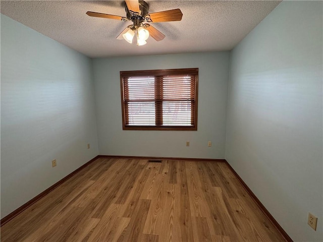1140 W Hamilton Ave Unit 1140, Eau Claire, WI 54701 - empty room with baseboards, a ceiling fan, wood finished floors, and a textured ceiling