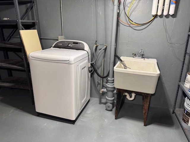 laundry area with a sink, laundry area, and washer / clothes dryer