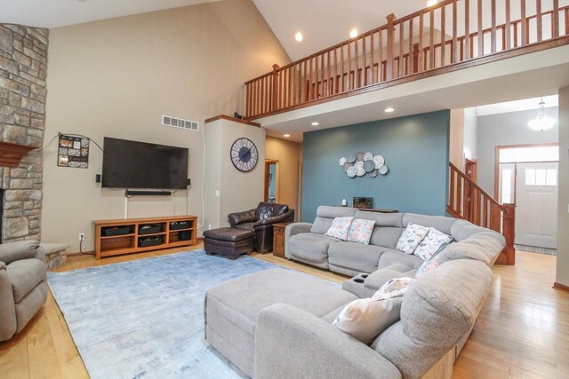 W6250 Apple Ln, Fort Atkinson, WI 53538 - living area featuring high vaulted ceiling, wood finished floors, stairway, a fireplace, and recessed lighting